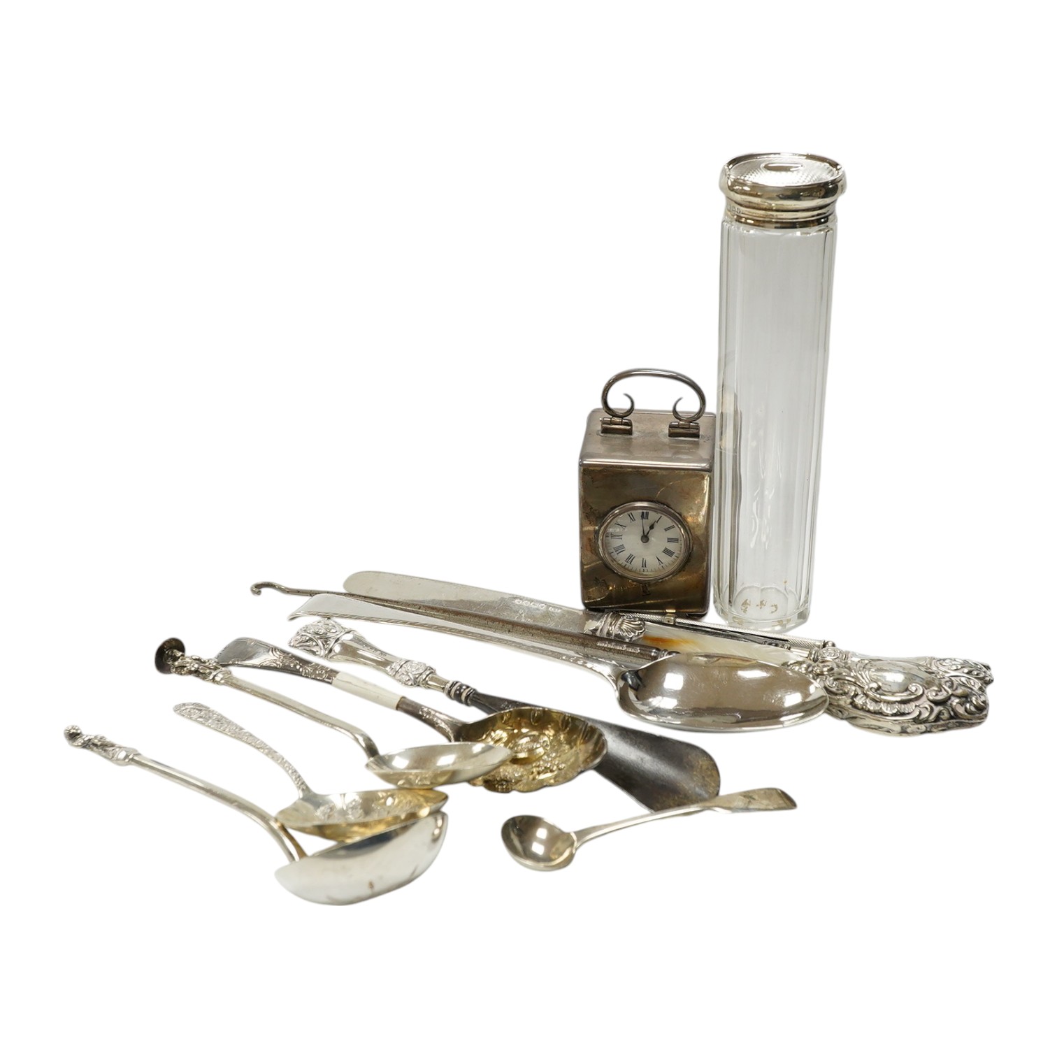 An Edwardian silver cased miniature carriage timepiece, by William Comyns, 67mm, London, 1901, together with a small quantity of assorted sterling or silver items, including flatware. Condition - poor to fair